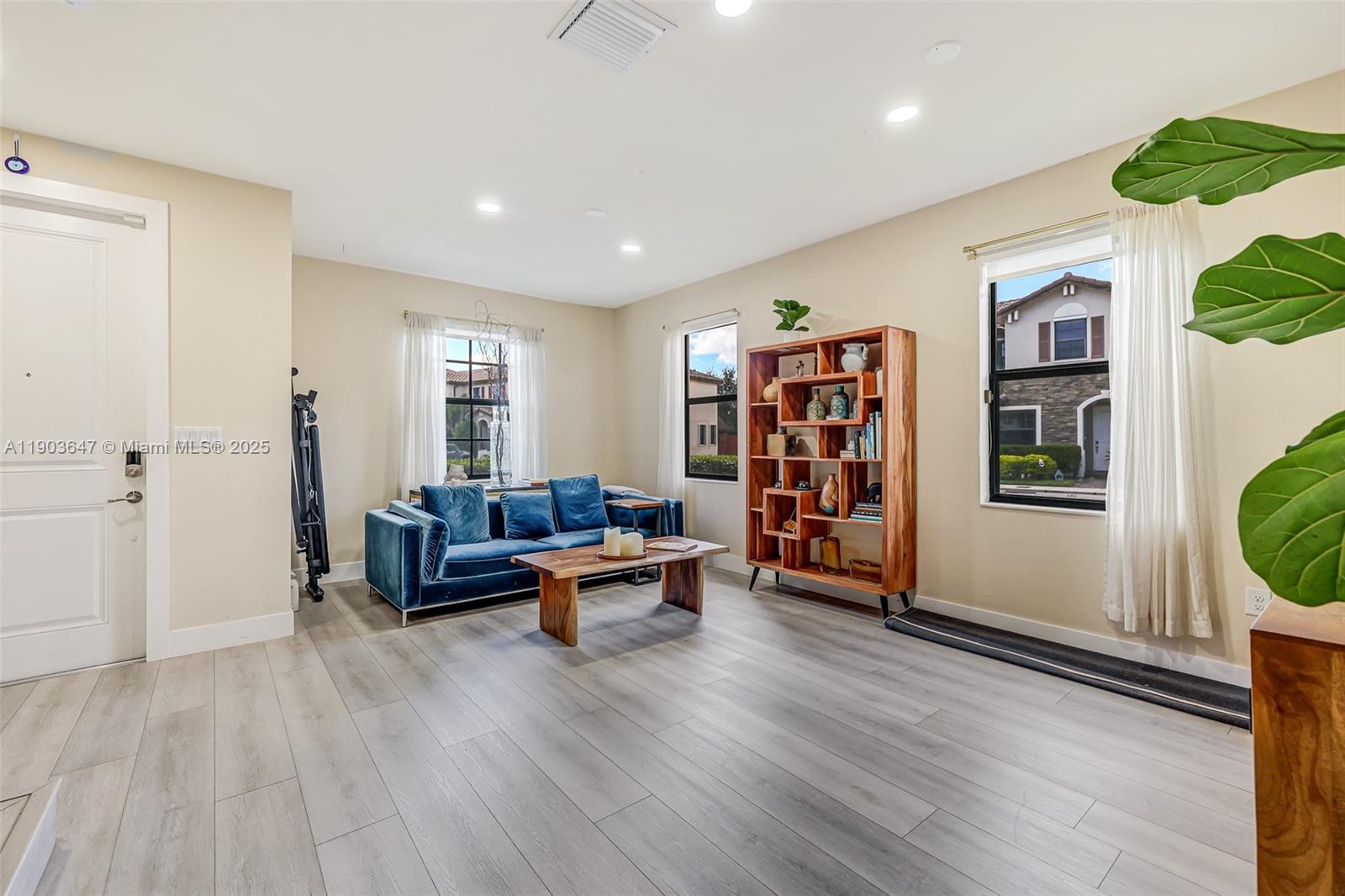 15097 Southwest 115th Street Miami, FL 33196 - Photo 7 of 44 a living room with furniture and a wooden floor