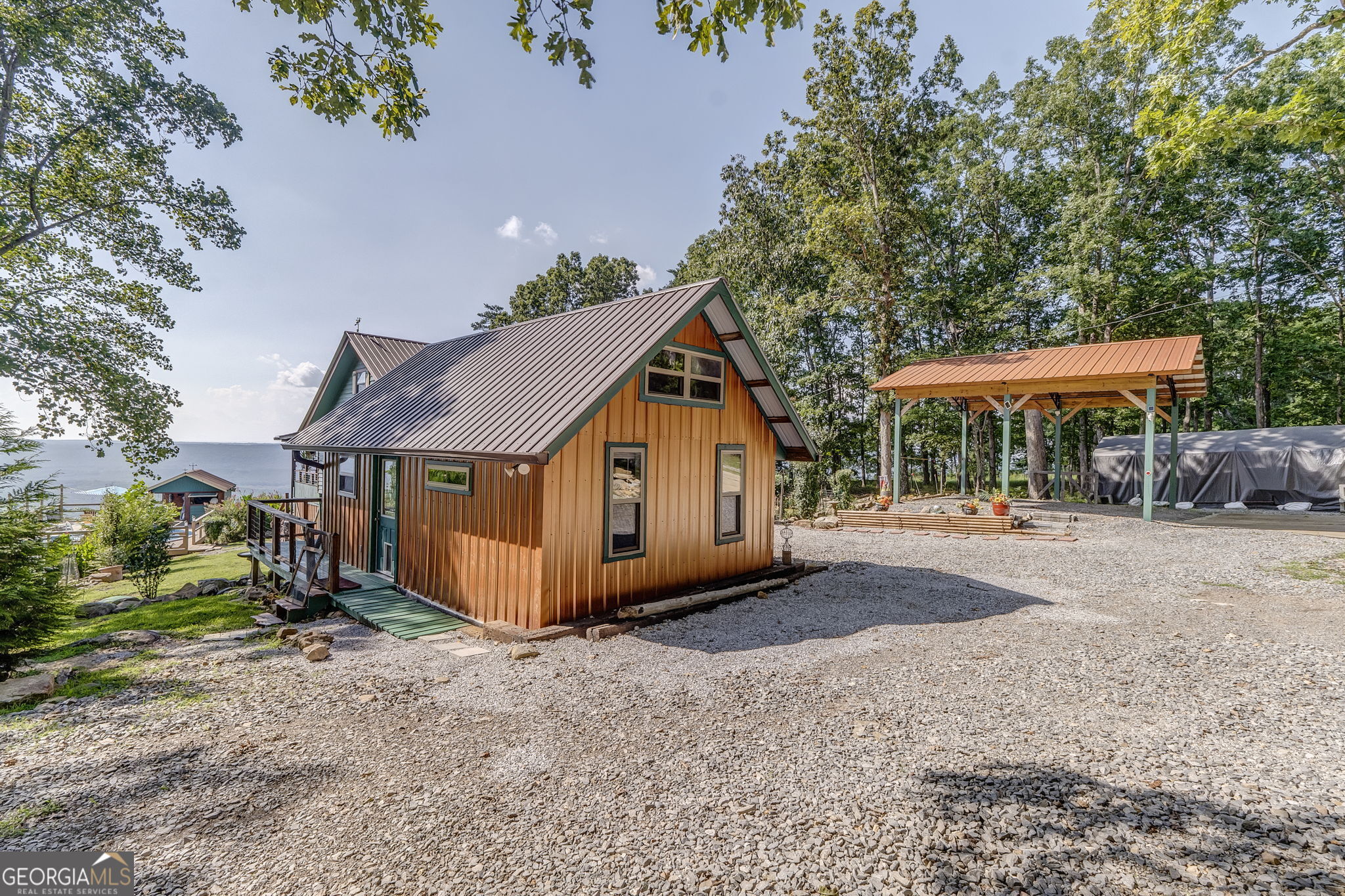 7896 Old State Road Menlo, GA 30731 - Photo 50 of 79 a view of a house with a yard and table and chairs under an umbrella