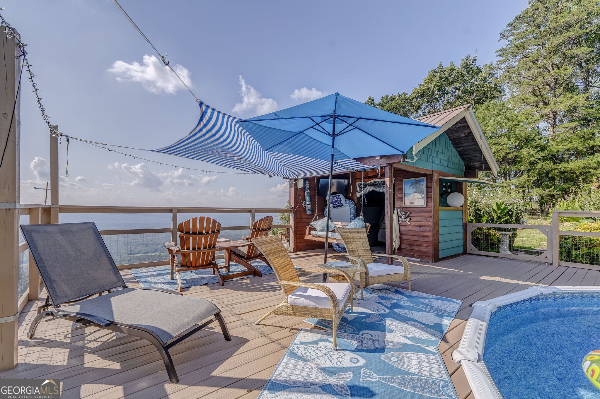 7896 Old State Road Menlo, GA 30731 - Photo 65 of 79 a view of a patio with table and chairs under an umbrella