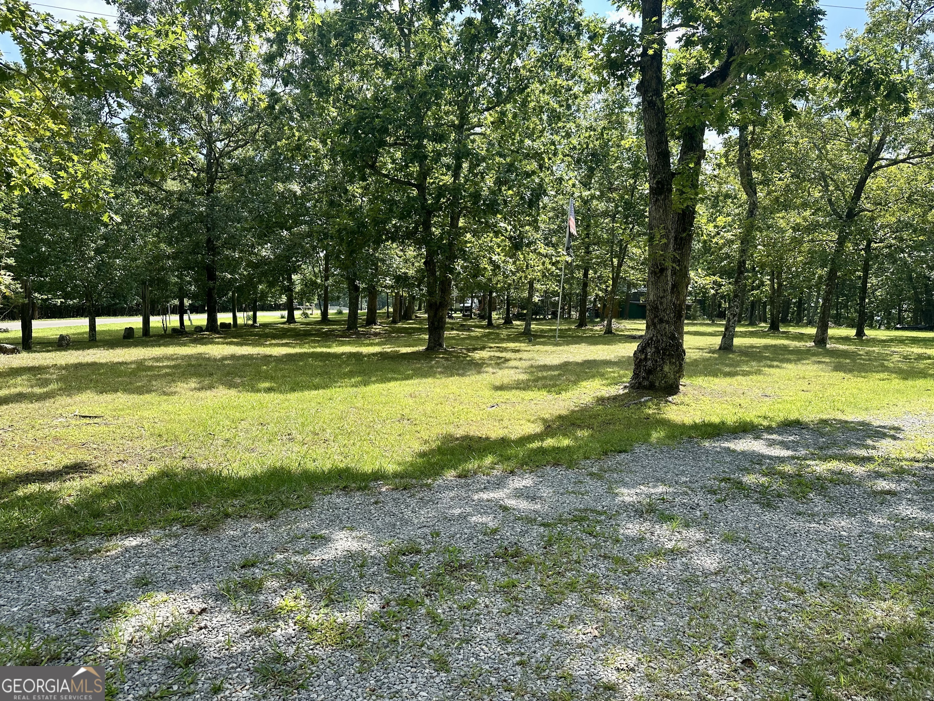7896 Old State Road Menlo, GA 30731 - Photo 74 of 79 a view of a swimming pool with a big yard and large trees