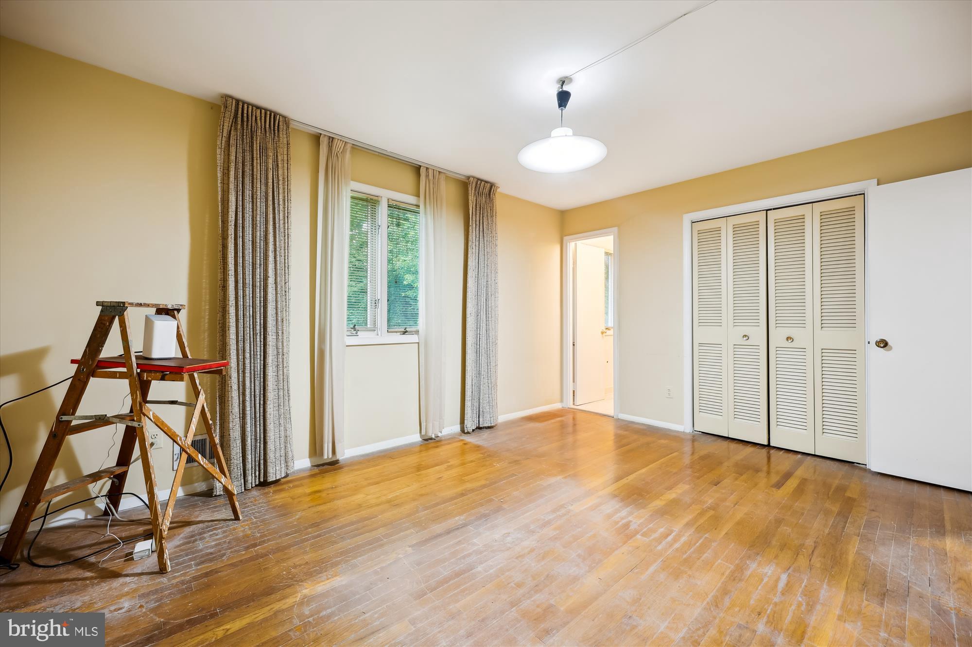 10205 Capitol View Avenue Silver Spring, MD 20910 - Photo 12 of 27 a view of an empty room with wooden floor and a window