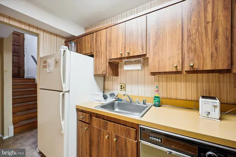 a kitchen with a refrigerator and a sink