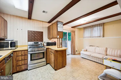 a kitchen with cabinets and stainless steel appliances