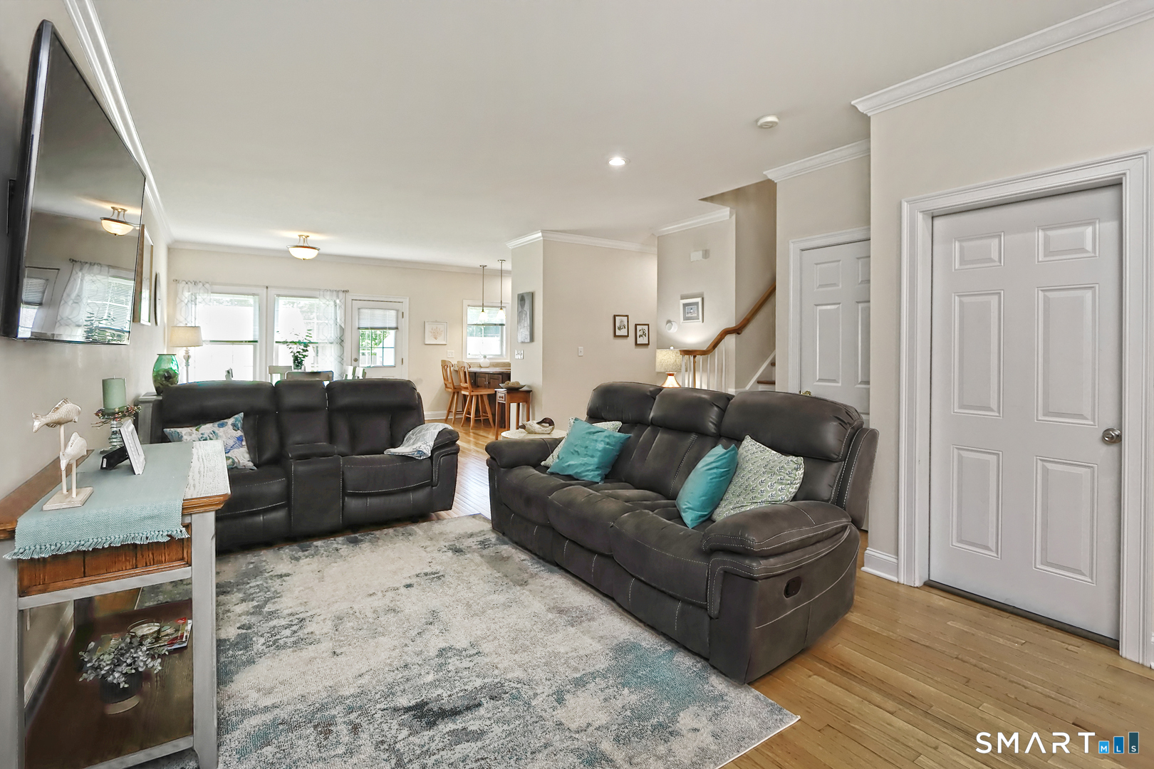 102 Lantern Court, Unit 102 Clinton, CT 06413 - Photo 12 of 36 a living room with furniture and a flat screen tv