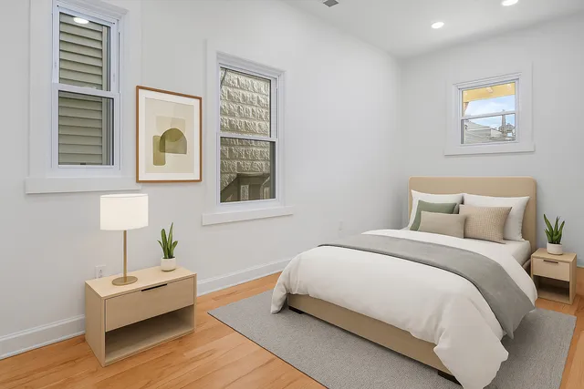 a bedroom with a bed and wooden floor