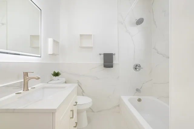 a bathroom with a sink a toilet and bathtub