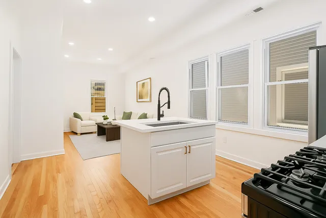 a kitchen with sink refrigerator and stove