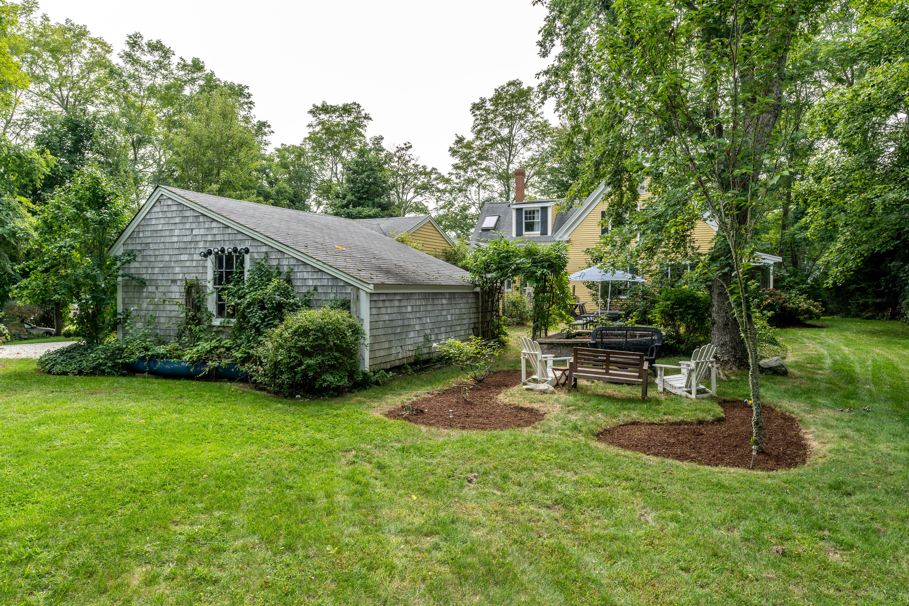 120 Bridge Road Eastham, MA 02642 - Photo 29 of 48 a view of a house with backyard sitting area and garden
