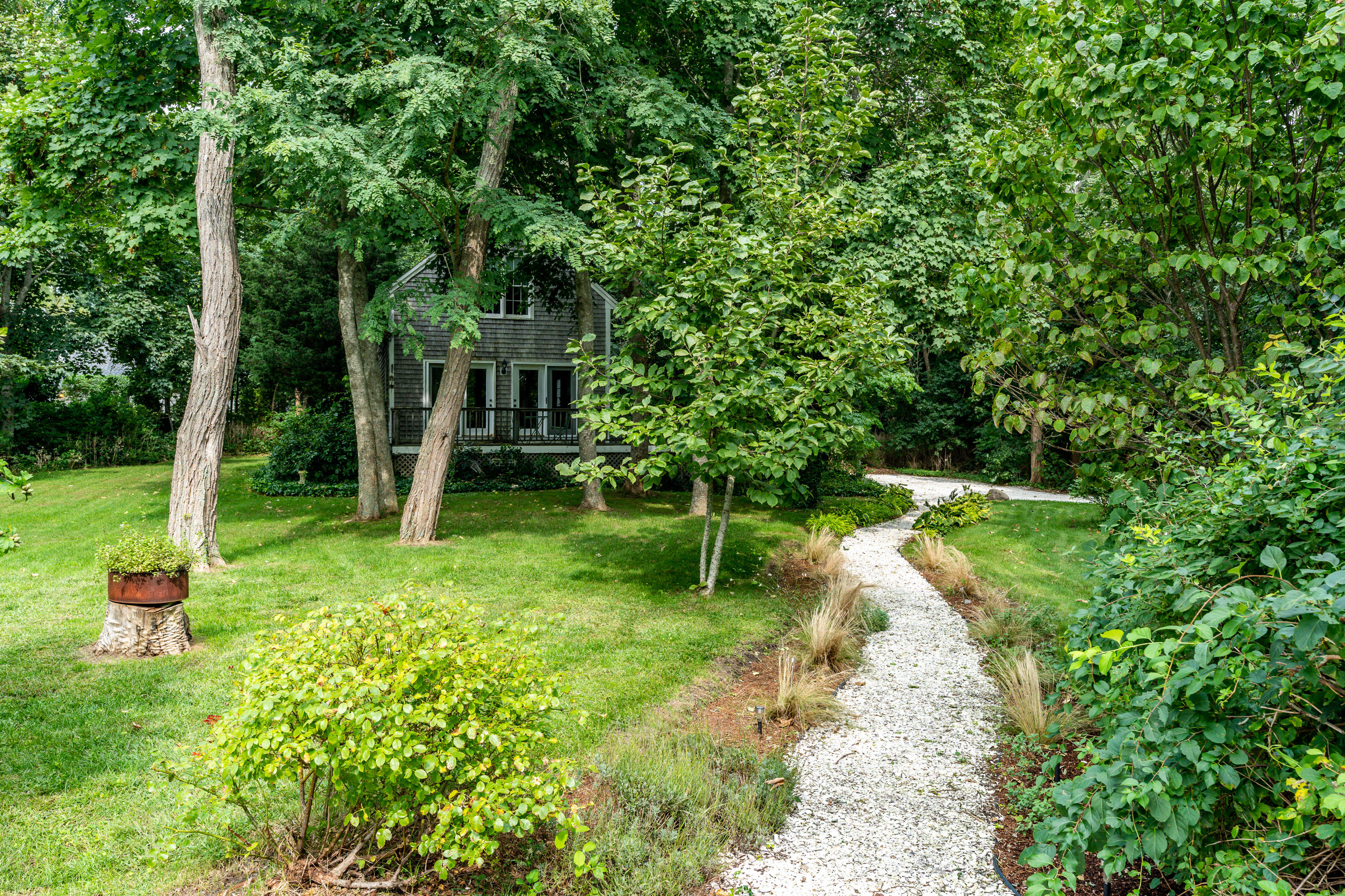 120 Bridge Road Eastham, MA 02642 - Photo 35 of 48 a view of a garden with a tree