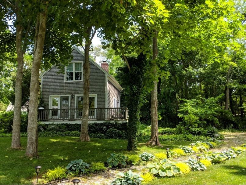 120 Bridge Road Eastham, MA 02642 - Photo 36 of 48 a backyard of a house with lots of green space