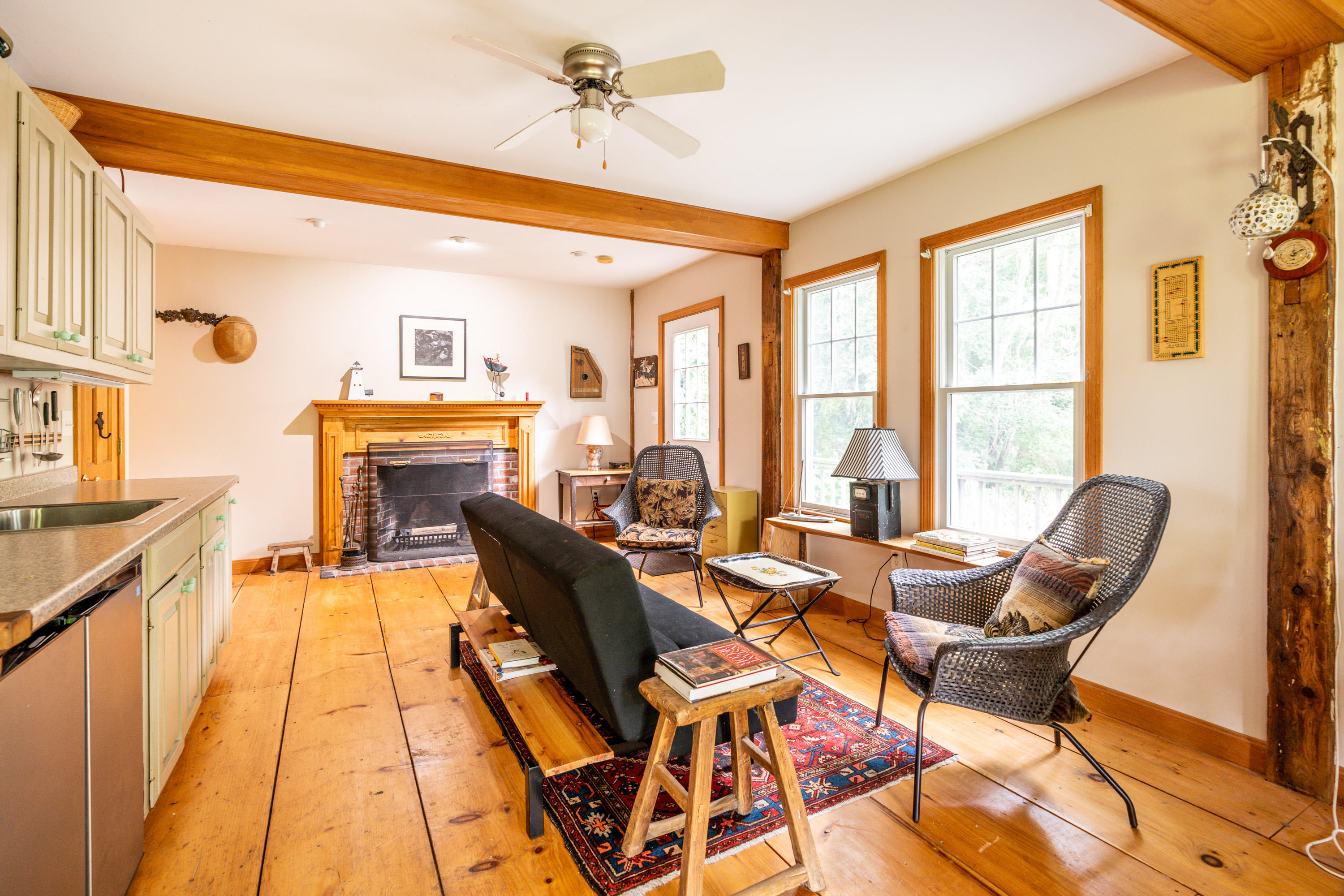 120 Bridge Road Eastham, MA 02642 - Photo 39 of 48 a dining room with furniture a fireplace and wooden floor