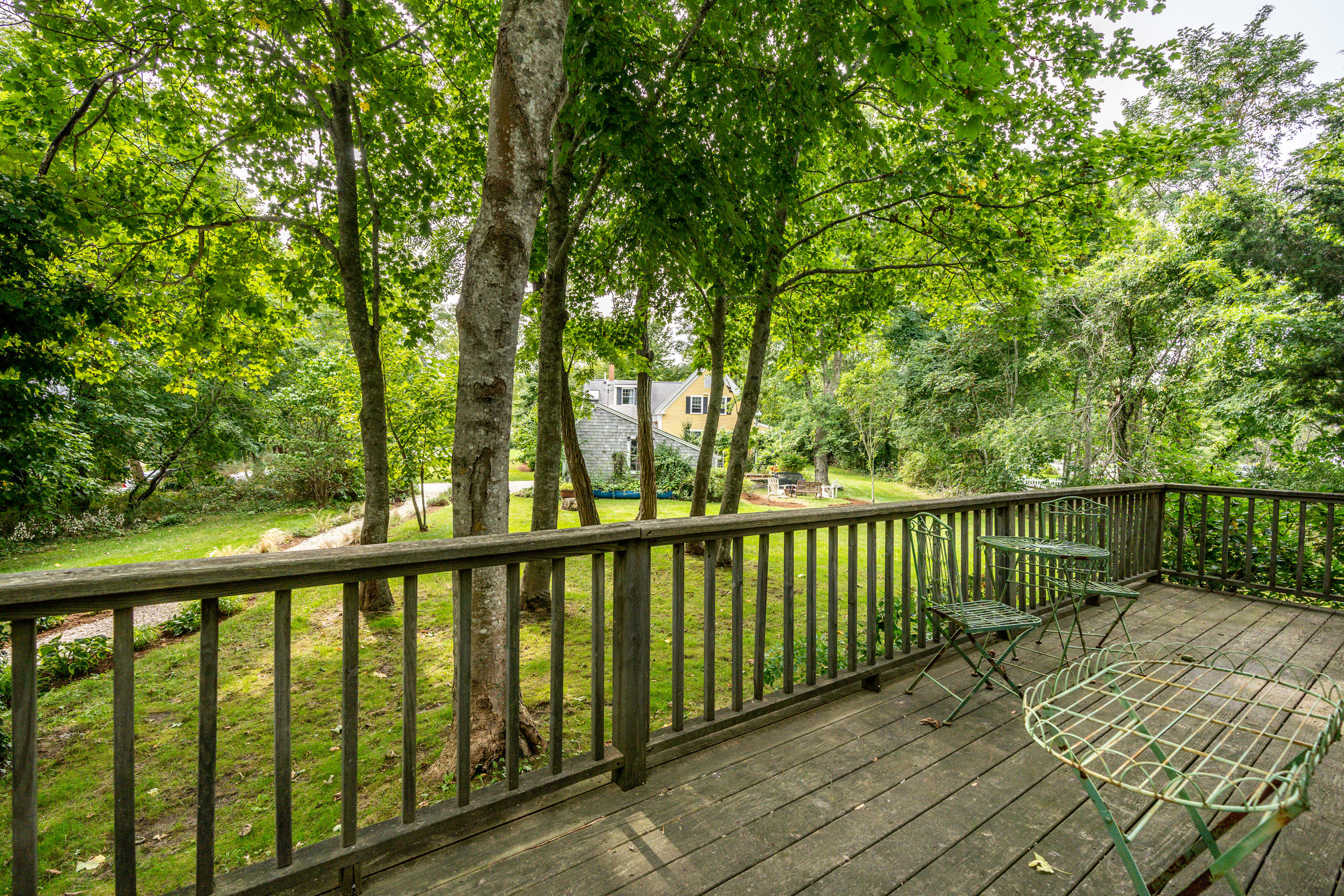 120 Bridge Road Eastham, MA 02642 - Photo 43 of 48 a balcony with trees in front of it