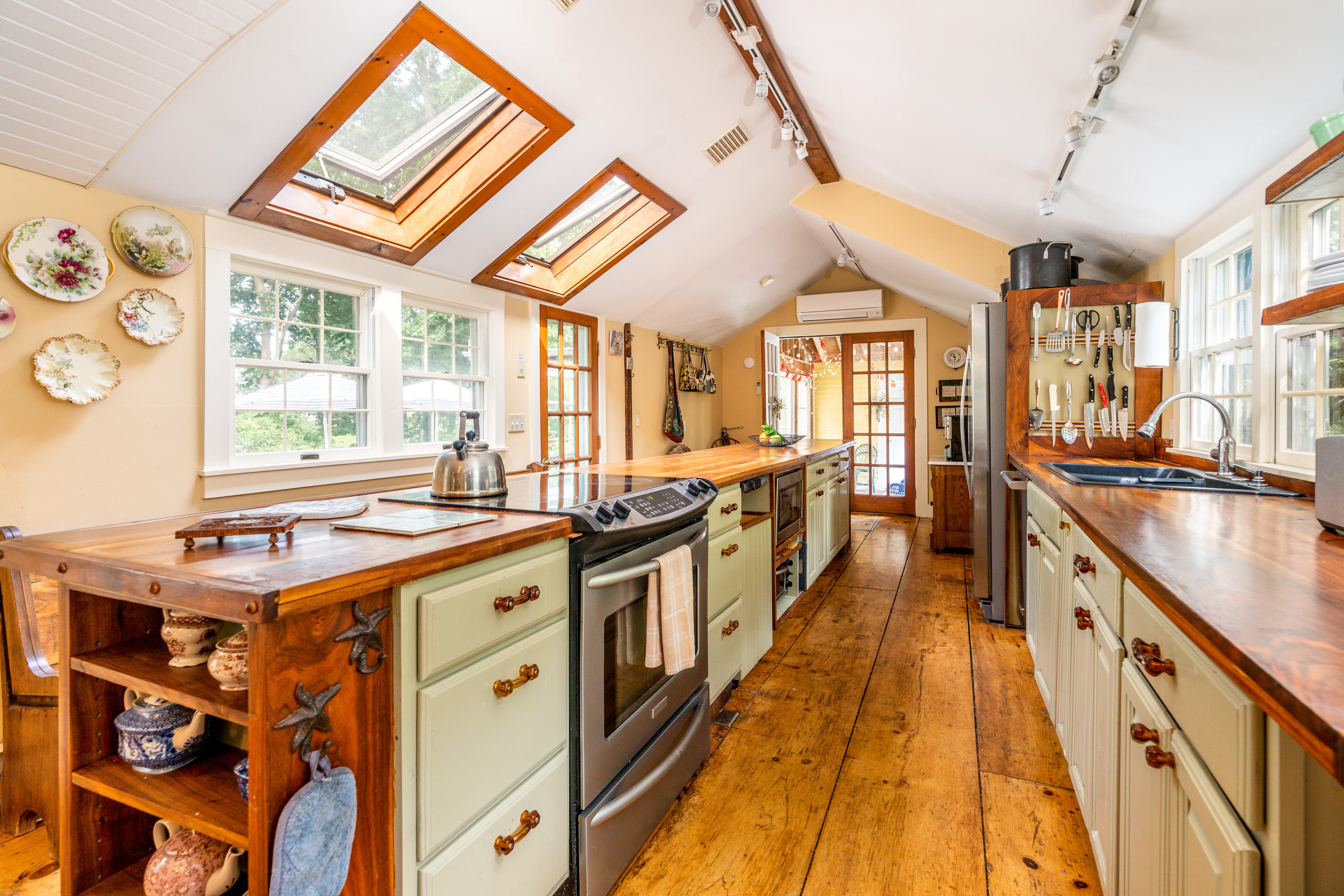 120 Bridge Road Eastham, MA 02642 - Photo 9 of 48 a kitchen with stainless steel appliances granite countertop a stove and a large window
