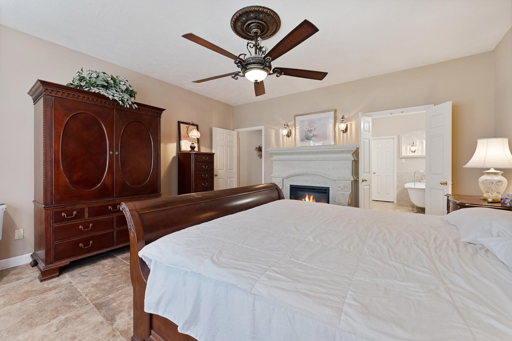 19309 Dianeshire Drive Spring, TX 77388 - Photo 18 of 33 a bedroom with a bed and a chandelier