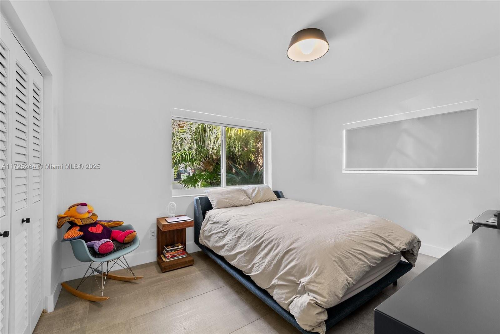 2104 Northeast 124th Street North Miami, FL 33181 - Photo 11 of 26 a bedroom with a bed and a window