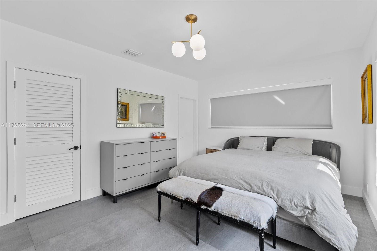 2104 Northeast 124th Street North Miami, FL 33181 - Photo 12 of 26 a bedroom with a bed and a dresser