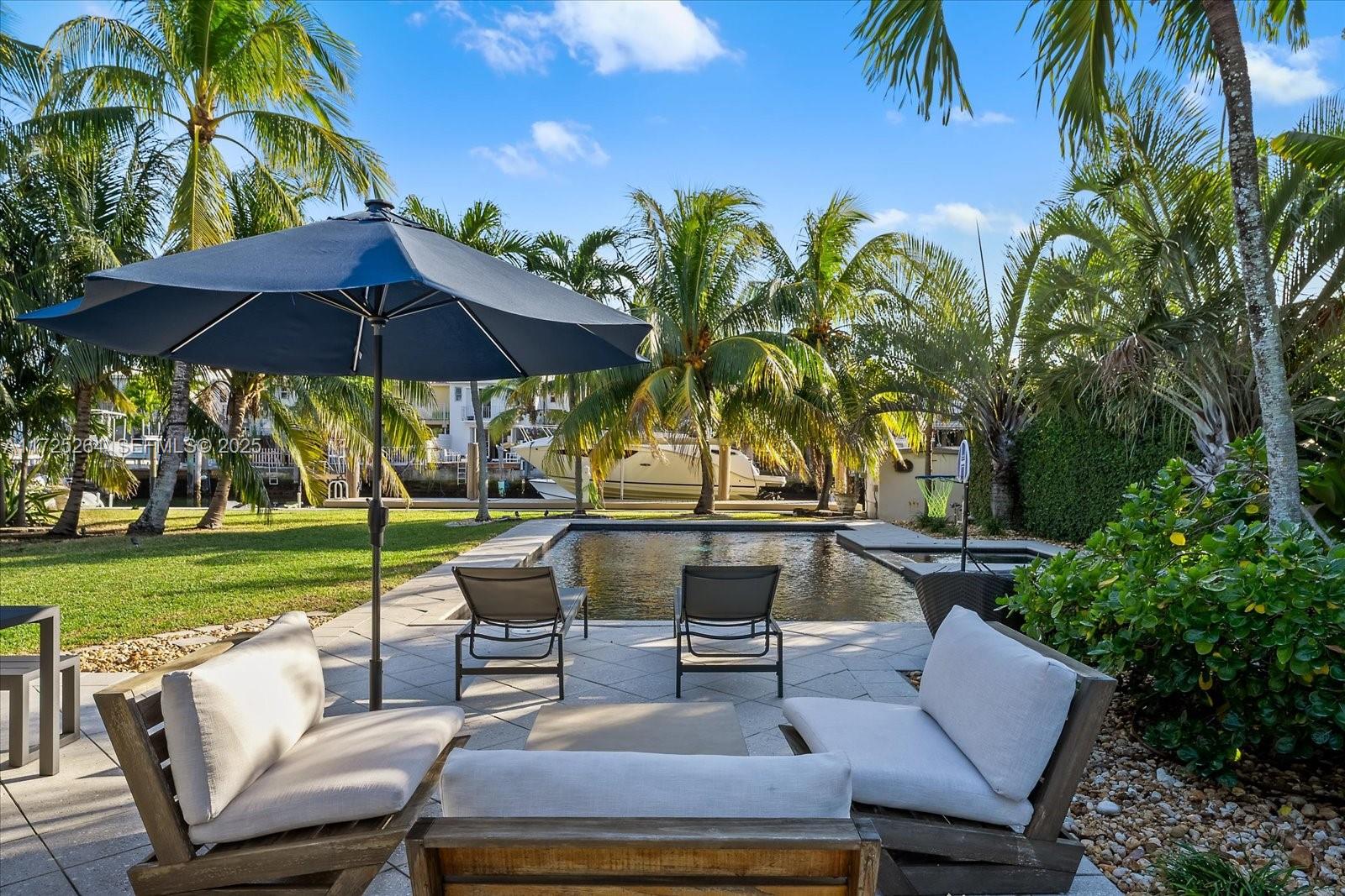 2104 Northeast 124th Street North Miami, FL 33181 - Photo 15 of 26 a view of a backyard with sitting area and furniture