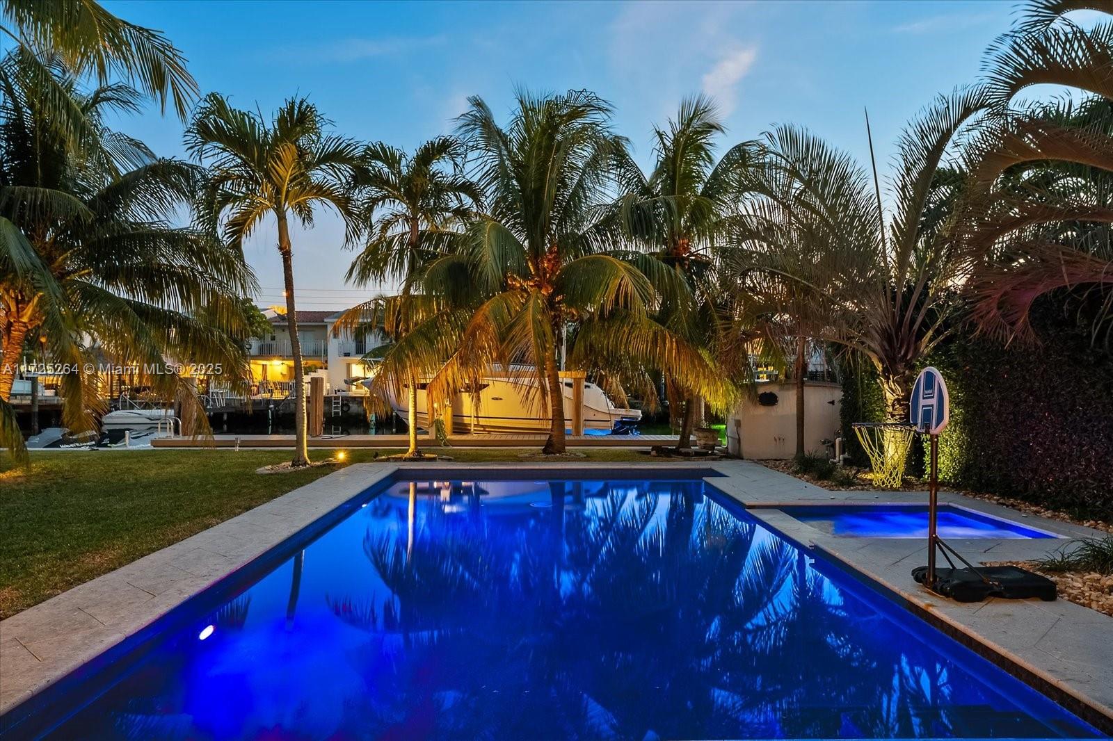2104 Northeast 124th Street North Miami, FL 33181 - Photo 2 of 26 a view of outdoor space with swimming pool and trees