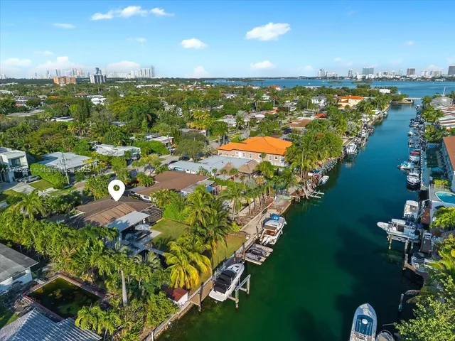 an aerial view of houses with a yard