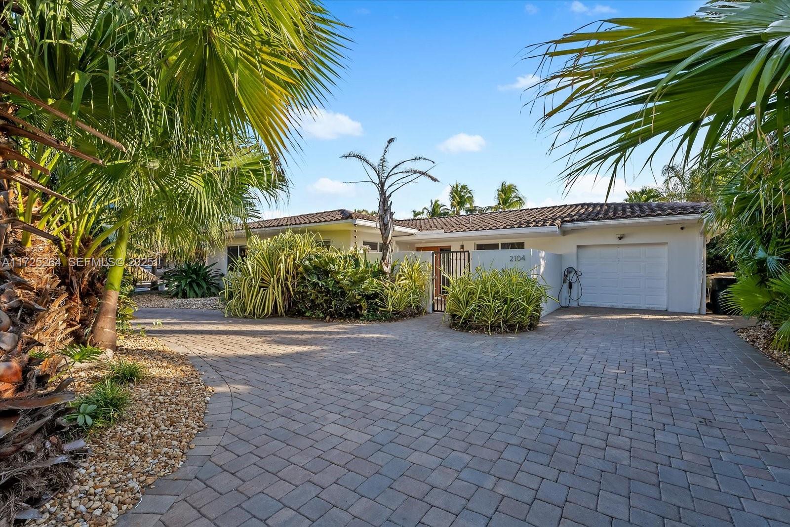 2104 Northeast 124th Street North Miami, FL 33181 - Photo 3 of 26 a view of a house with a yard and potted plants