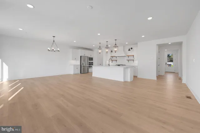 a view of a kitchen with a sink and a refrigerator