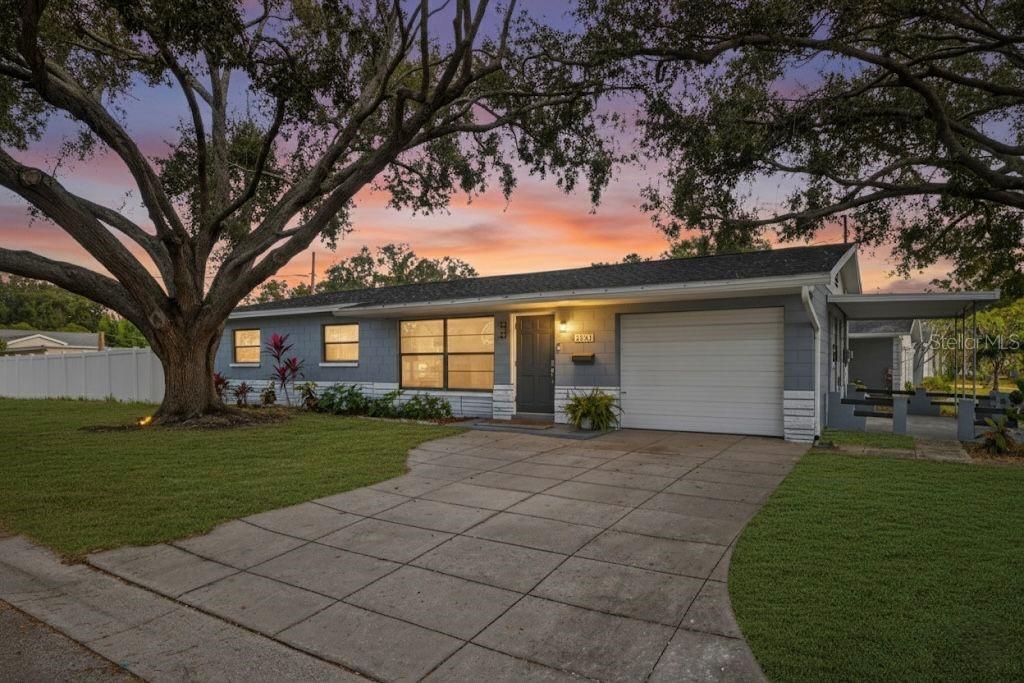 6501 Livingston Avenue North St. Petersburg, FL 33702 - Photo 1 of 31 a front view of a house with a garden and trees