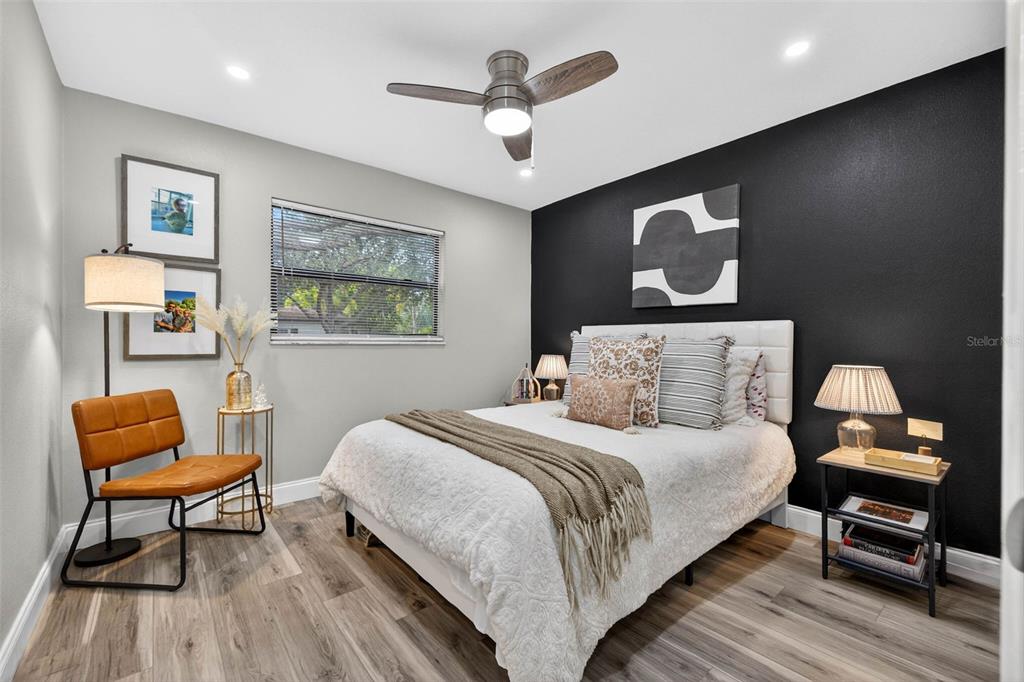 6501 Livingston Avenue North St. Petersburg, FL 33702 - Photo 14 of 31 a bedroom with a bed and a chair