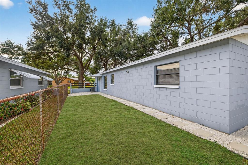 6501 Livingston Avenue North St. Petersburg, FL 33702 - Photo 19 of 31 a backyard of a house with lots of green space