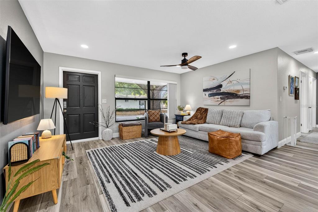 6501 Livingston Avenue North St. Petersburg, FL 33702 - Photo 3 of 31 a living room with furniture and a wooden floor