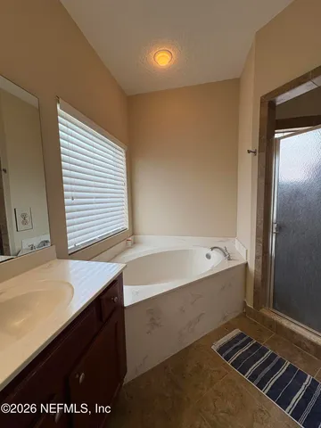 a bathroom with a bathtub and a sink