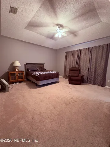 a living room with furniture and a ceiling fan