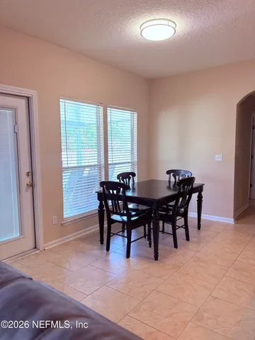 a view of a dining room with furniture and a window