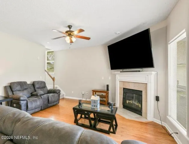 a living room with furniture a fireplace and a flat screen tv