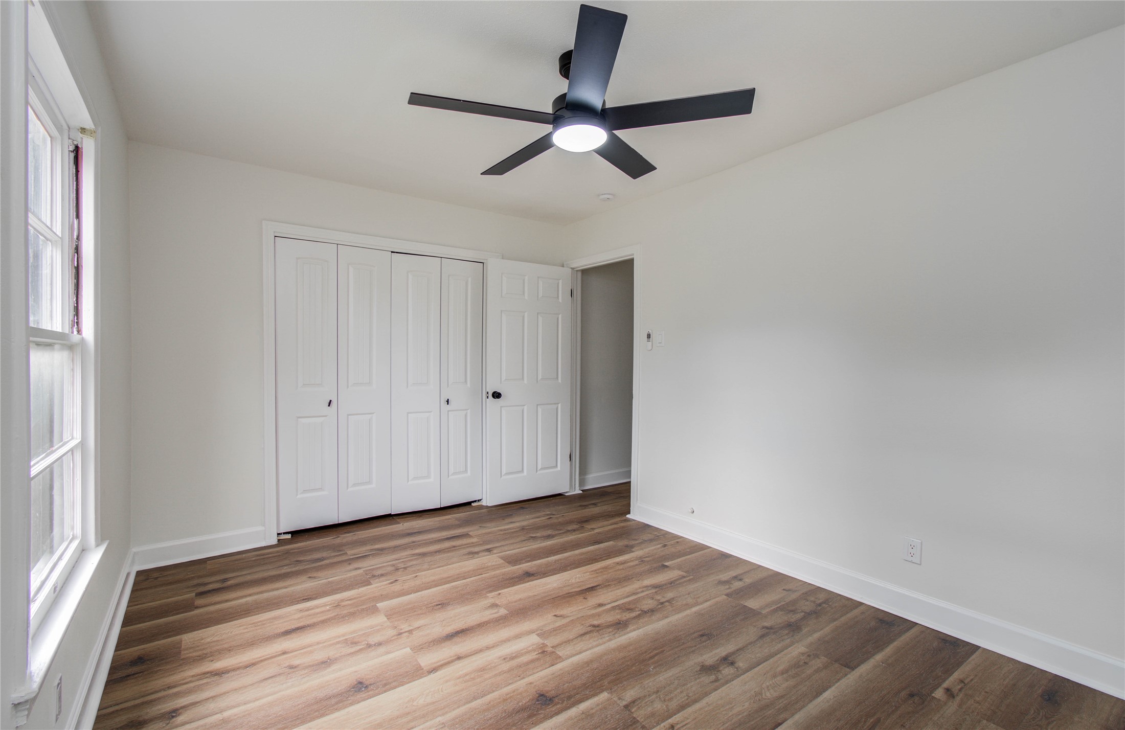 2417 Pecan Street Dickinson, TX 77539 - Photo 37 of 43 a view of empty room with wooden floor and fan