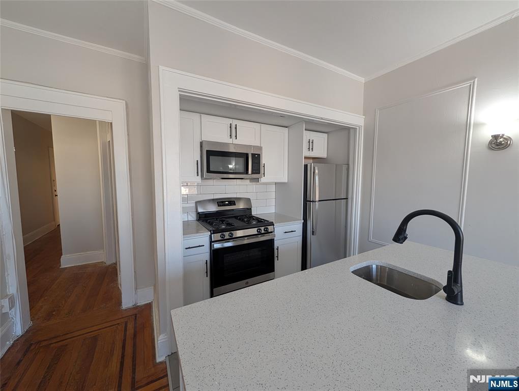 a kitchen with a refrigerator stove and a sink
