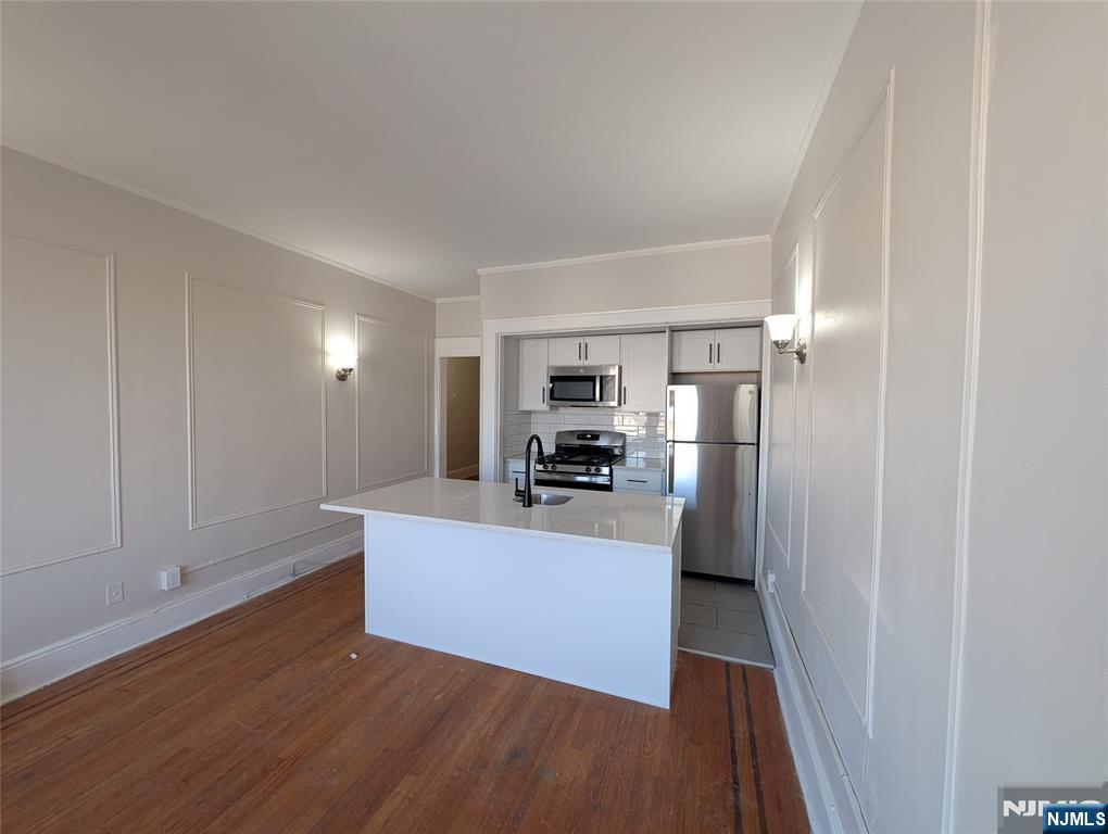 85 Anderson Street, Unit C6 Hackensack, NJ 07601 - Photo 2 of 10 a kitchen with stainless steel appliances a refrigerator and a stove top oven