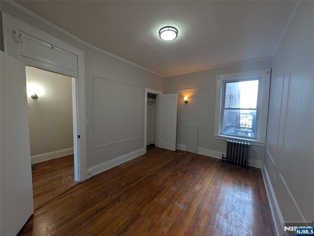 85 Anderson Street, Unit C6 Hackensack, NJ 07601 - Photo 4 of 10 an empty room with wooden floor and windows