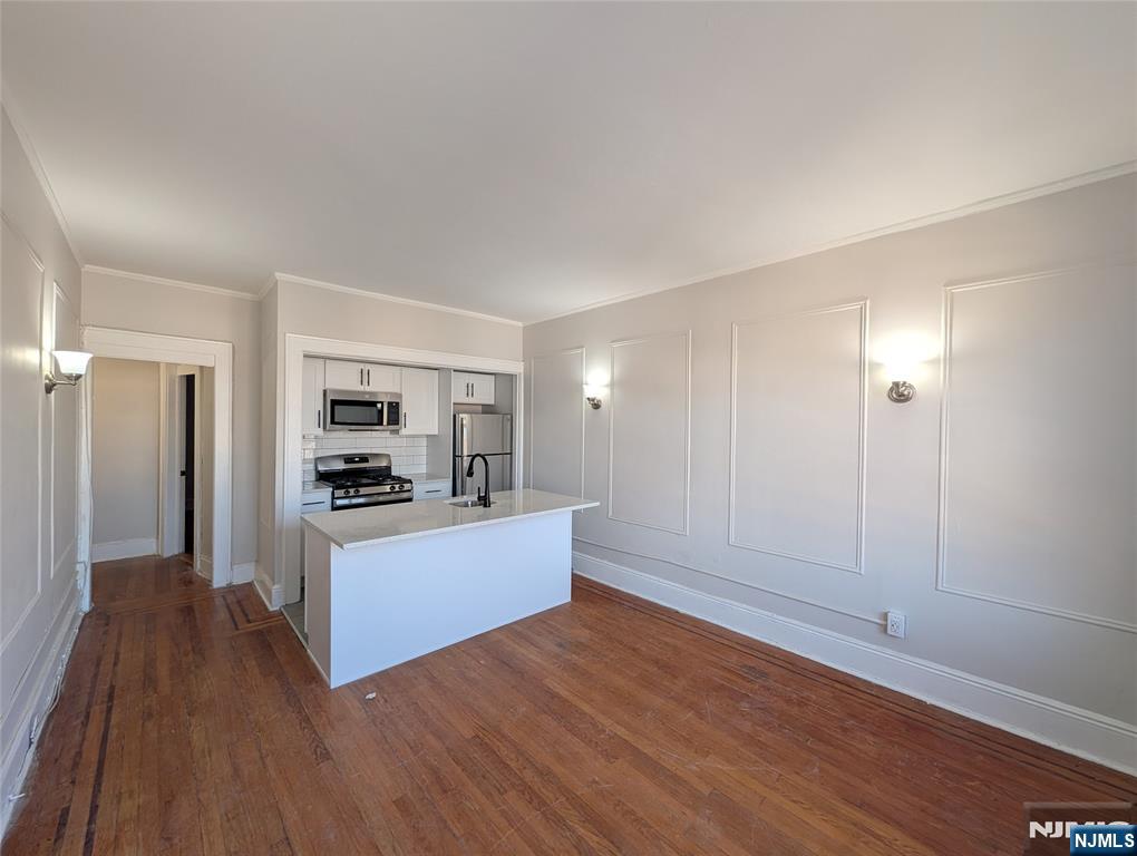 85 Anderson Street, Unit C6 Hackensack, NJ 07601 - Photo 6 of 10 a kitchen with stainless steel appliances a refrigerator and a stove top oven