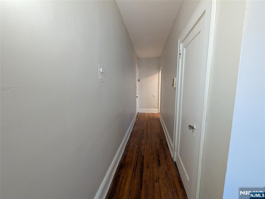 85 Anderson Street, Unit C6 Hackensack, NJ 07601 - Photo 9 of 10 a view of a hallway with a wooden floor