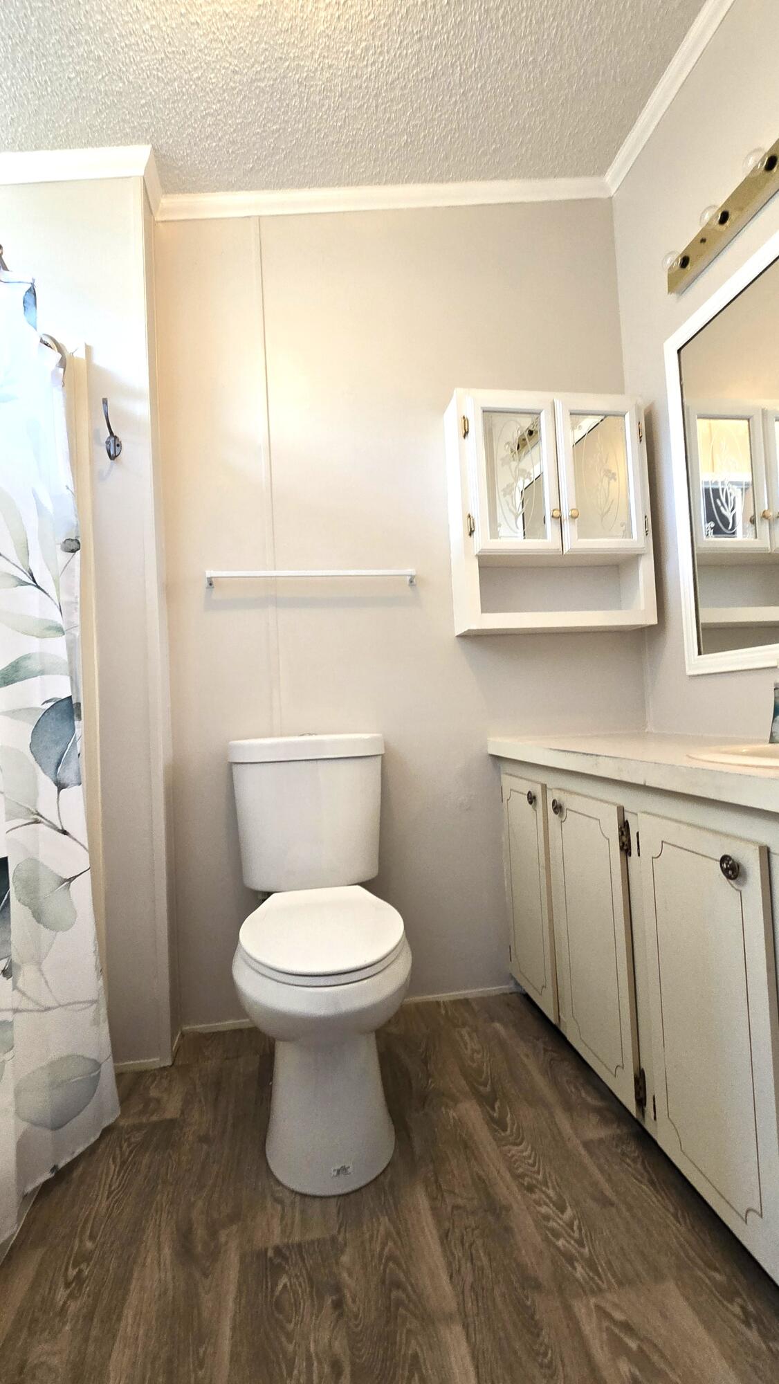 5680 Hemingway Court, Unit 15 Fort Pierce, FL 34982 - Photo 12 of 18 a white toilet sitting next to a bathroom sink
