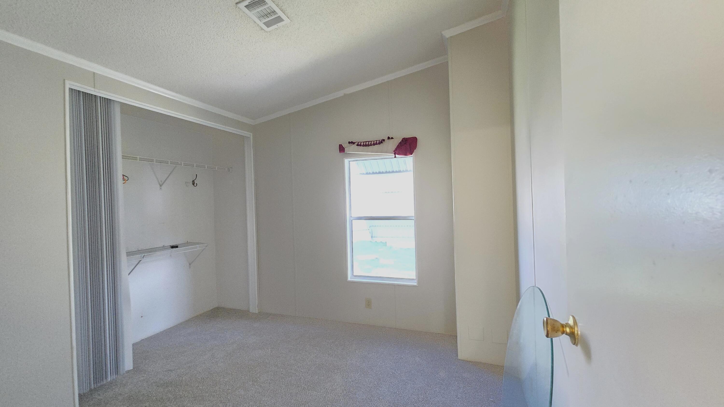 5680 Hemingway Court, Unit 15 Fort Pierce, FL 34982 - Photo 13 of 18 a view of an empty room and a window