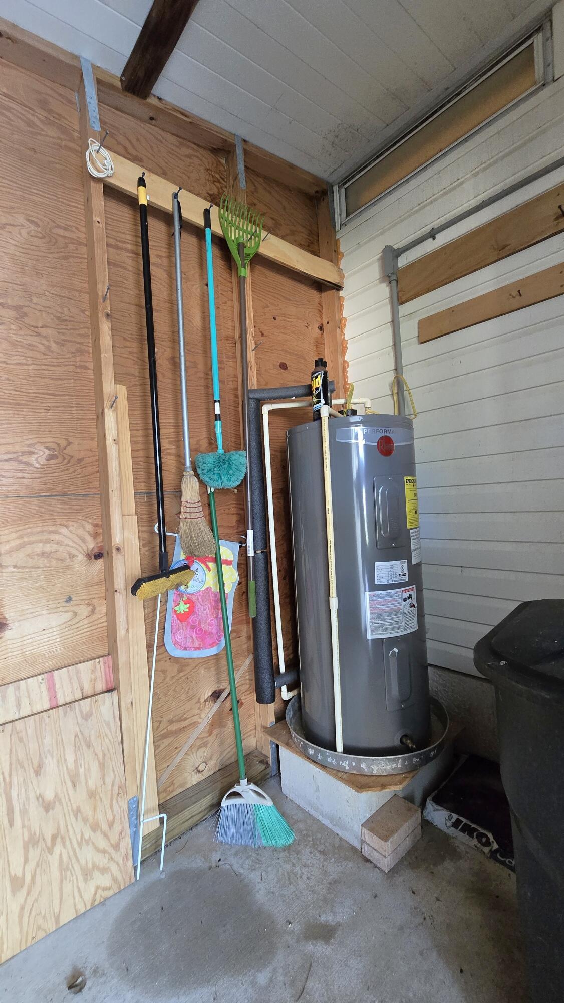 5680 Hemingway Court, Unit 15 Fort Pierce, FL 34982 - Photo 16 of 18 a view of a storage room with water heater and refrigerator