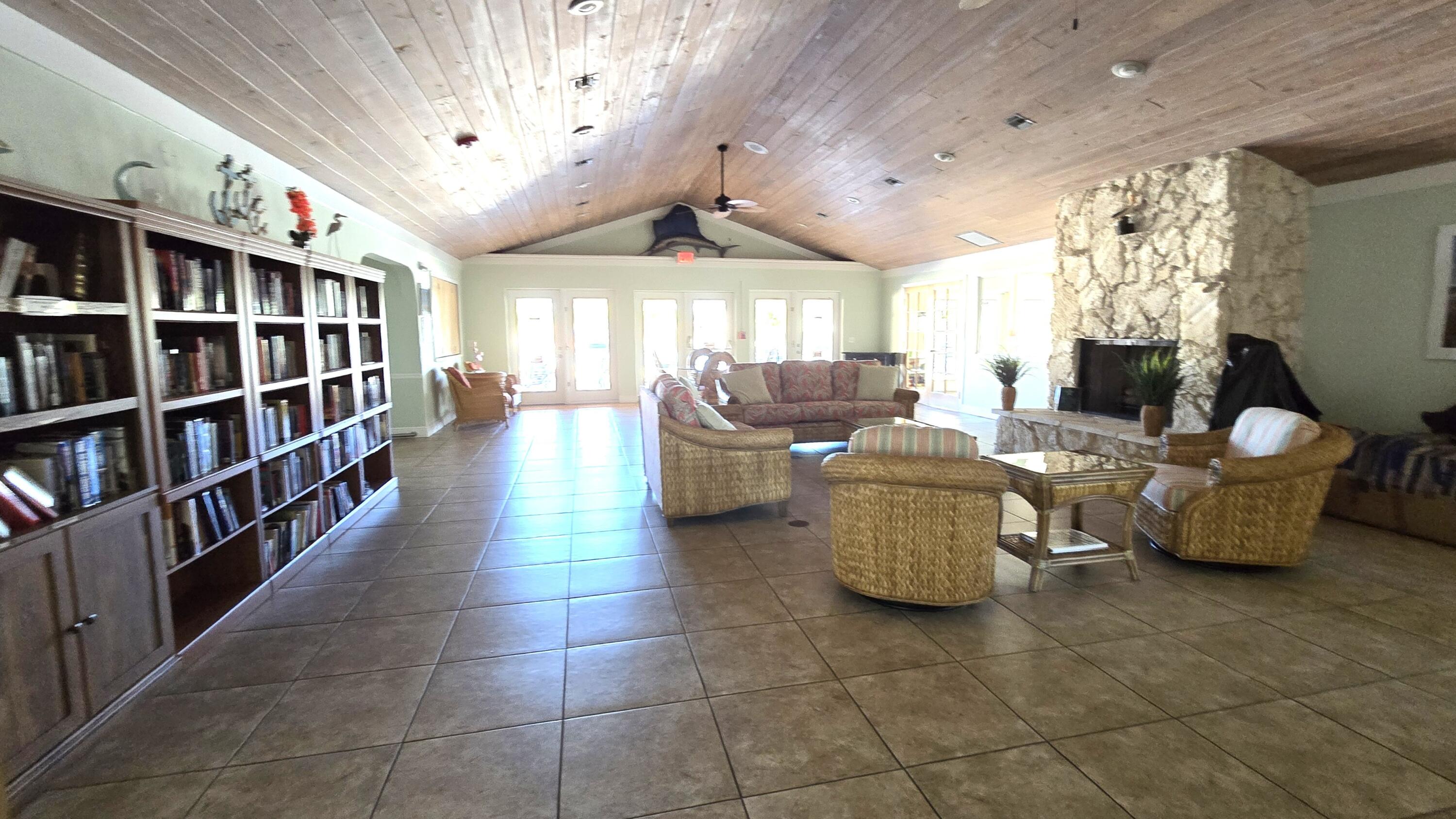 5680 Hemingway Court, Unit 15 Fort Pierce, FL 34982 - Photo 17 of 18 a living room with furniture cabinets and a book shelf