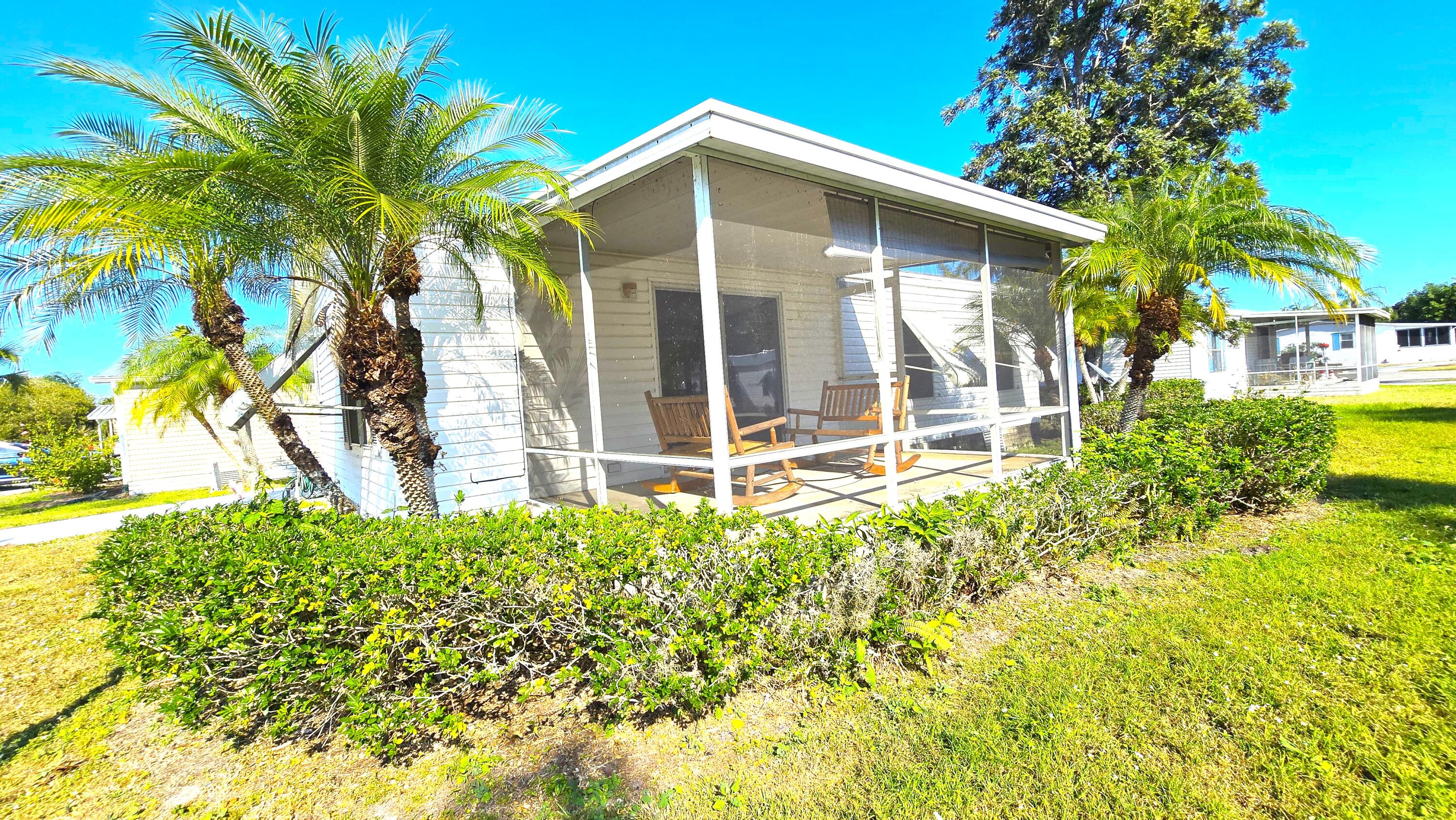 5680 Hemingway Court, Unit 15 Fort Pierce, FL 34982 - Photo 4 of 18 a front view of a house with a yard