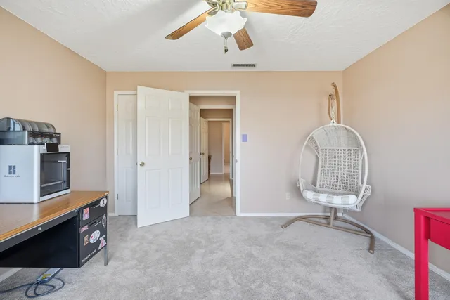 a view of a room with workspace and a window