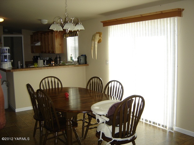 405 Schut Road Moxee, WA 98936 - Photo 5 of 11 a view of a dining room with furniture and window
