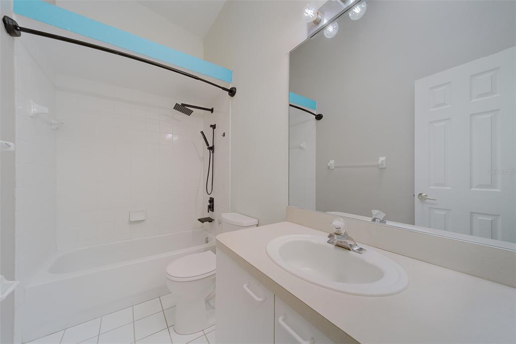 9241 Jake's Path Largo, FL 33771 - Photo 11 of 46 a bathroom with a granite countertop sink a toilet and shower