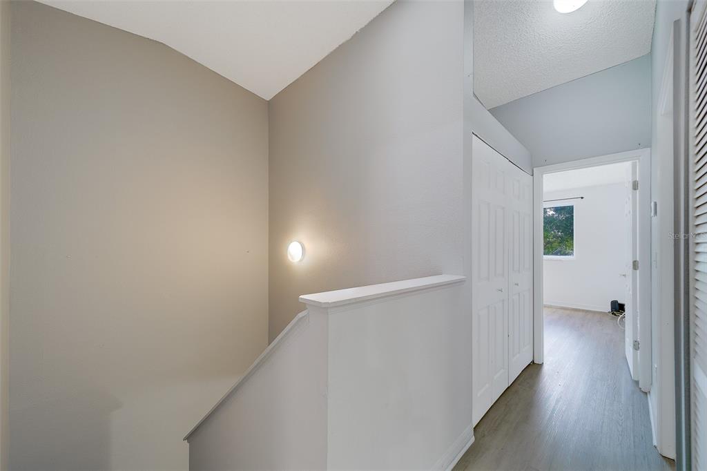 9241 Jake's Path Largo, FL 33771 - Photo 13 of 46 a view of a hallway with wooden floor