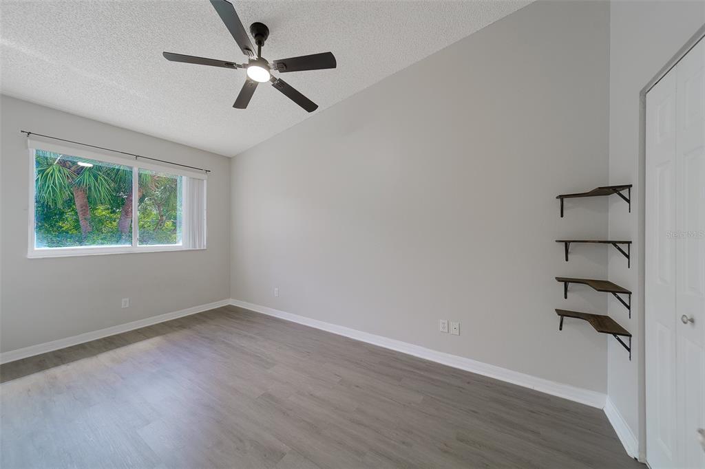 9241 Jake's Path Largo, FL 33771 - Photo 14 of 46 wooden floor in an empty room with a window
