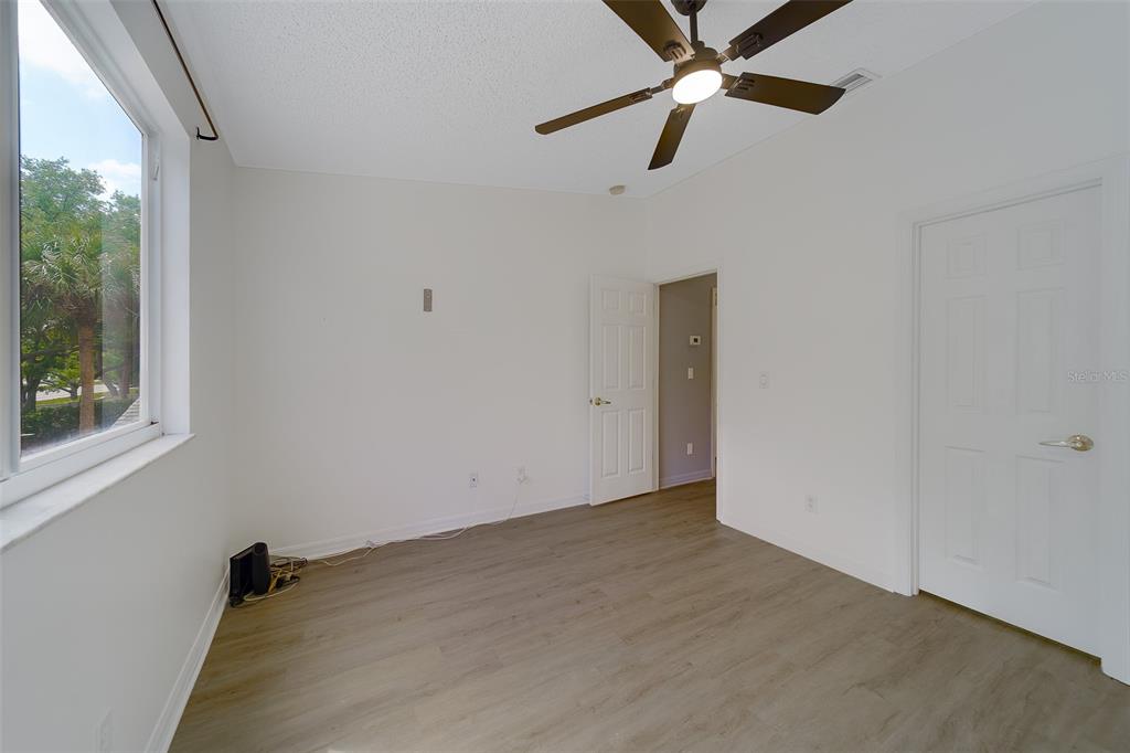 9241 Jake's Path Largo, FL 33771 - Photo 16 of 46 an empty room with a window and a fan